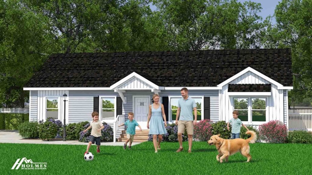 A family with three kids and a dog play on the lawn in front of a white modular home with a dark roof.